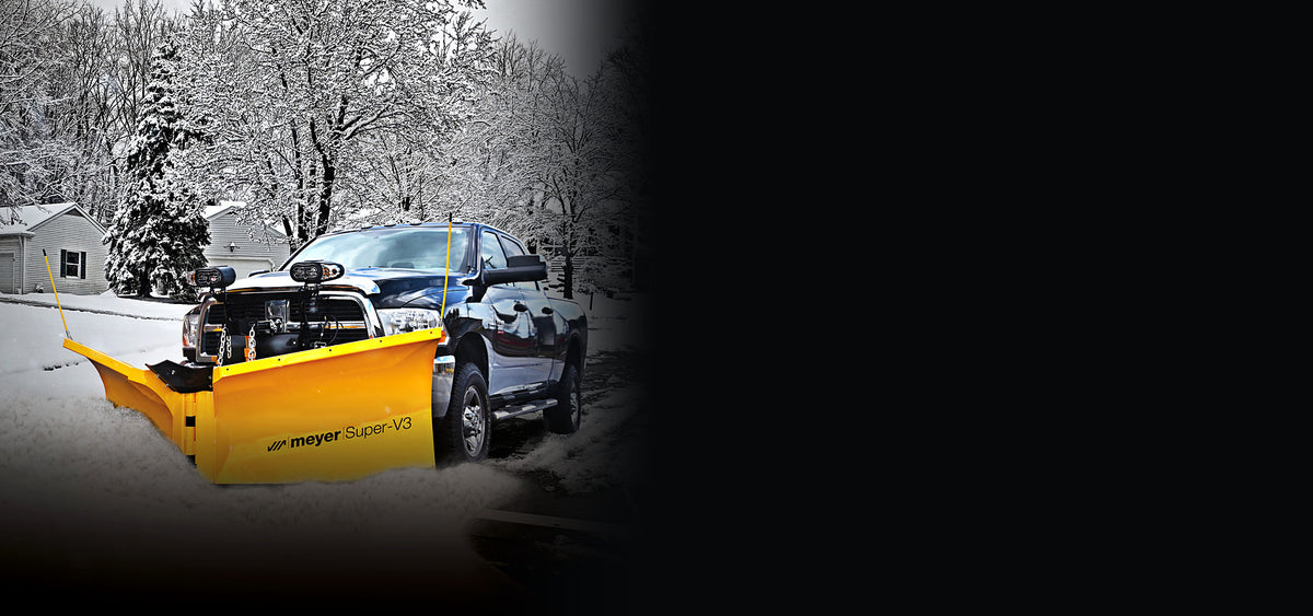 Meyer Super-V3 snow plow on a pickup truck plowing a snowy street
