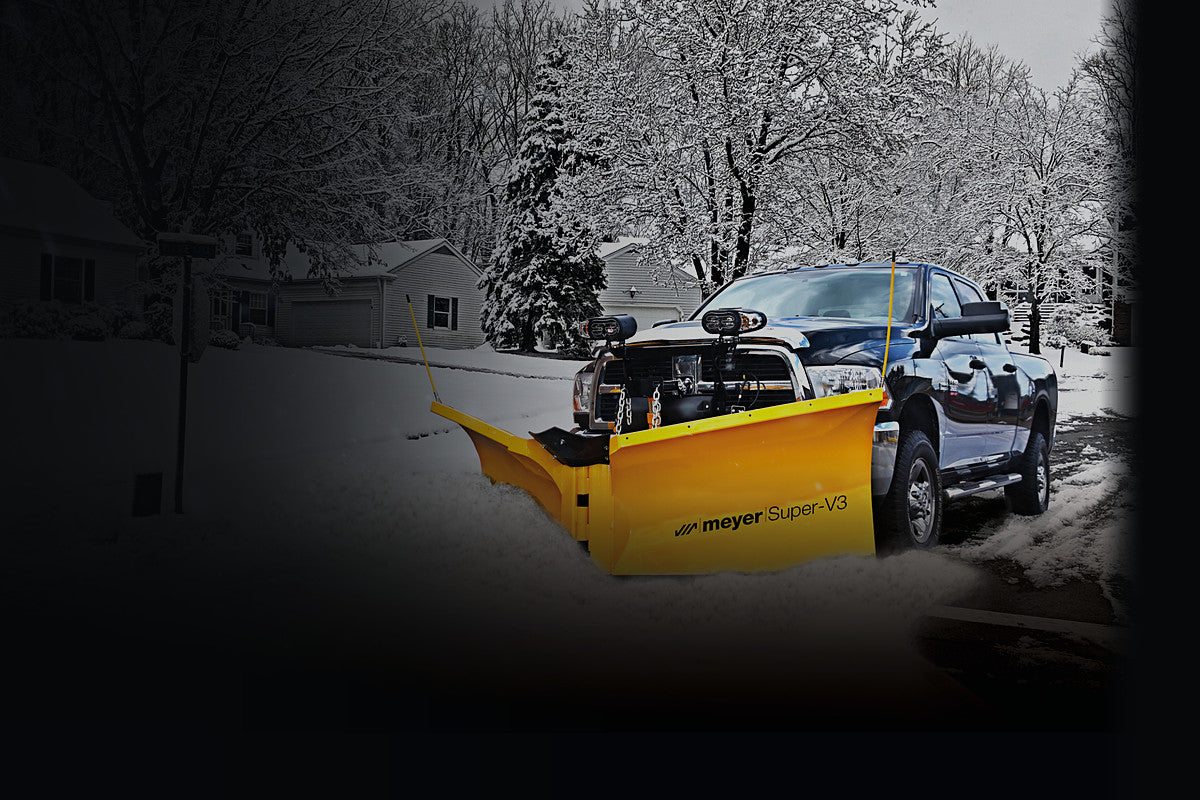 Meyer Super-V3 snow plow on a pickup truck plowing a snowy street