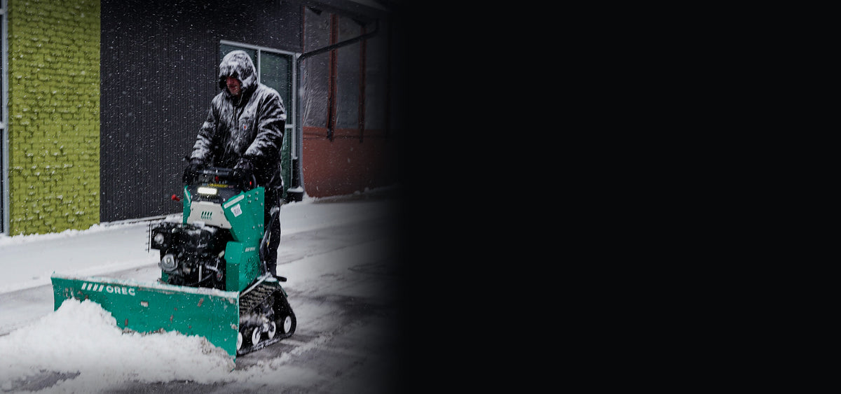 Orec Snow Rhino stand-on sidewalk plow clearing snow from a walkway