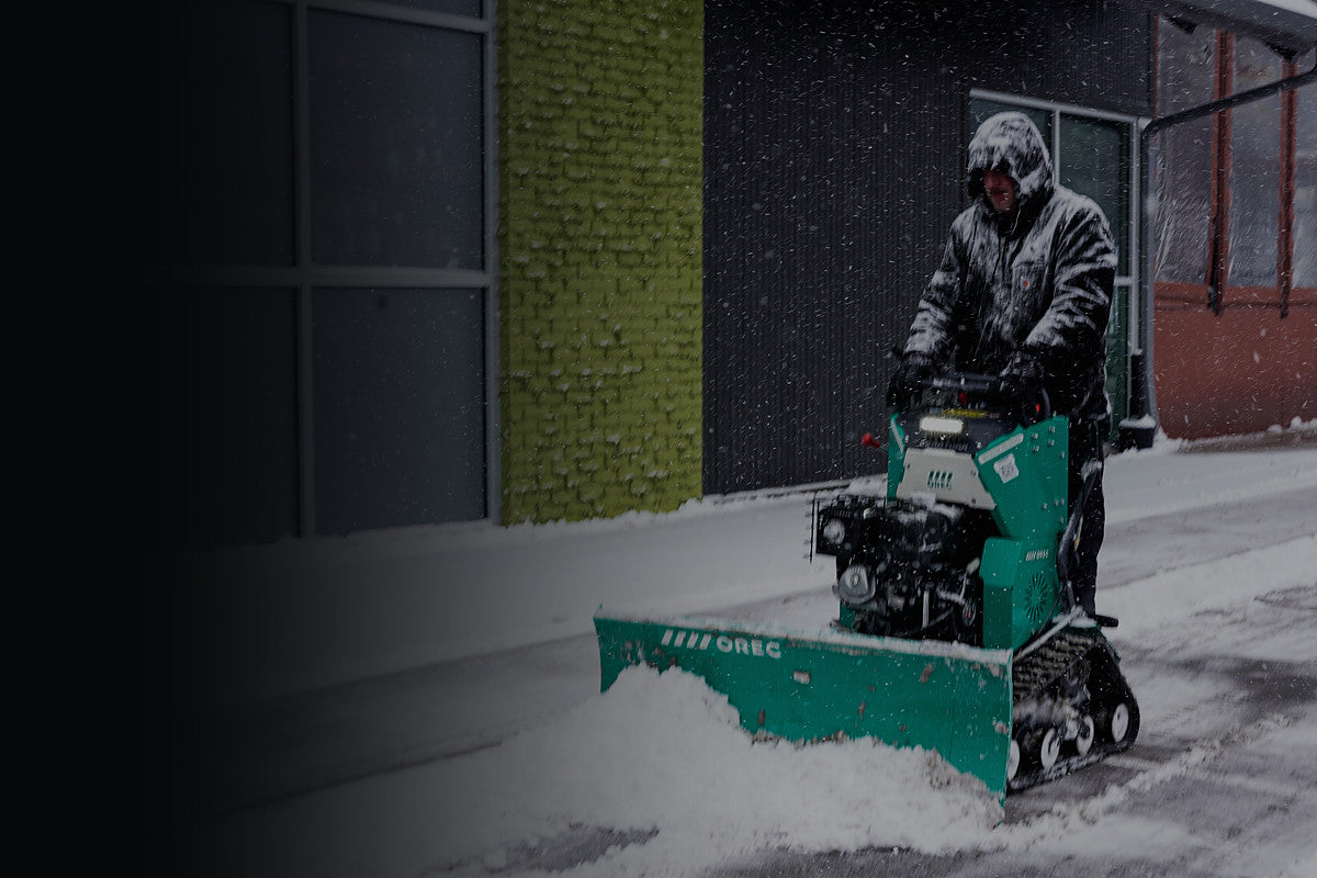 Orec Snow Rhino stand-on sidewalk plow clearing snow from a walkway